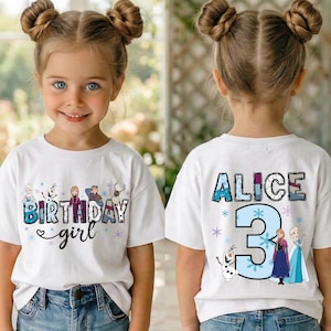 May include: A white t-shirt with the text "BIRTHDAY girl" and cartoon characters. The back of the shirt has the name "ALICE" and the number "3" with cartoon characters. The girl is wearing blue jeans.