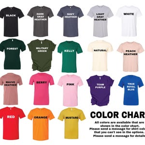 The image is a color chart displaying various t-shirt colors, including black, dark brown, navy, light gray, white, peach, natural, pink, purple, true royal blue, and orange.