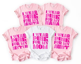 May include: Five t-shirts, four pink and one white, with the text "I WEAR PINK FOR MY DAUGHTER", "I WEAR PINK FOR MY NANA", "I WEAR PINK FOR MY SISTER", "I WEAR PINK FOR MY MOM", and "I WEAR PINK FOR MY AUNT" in pink.