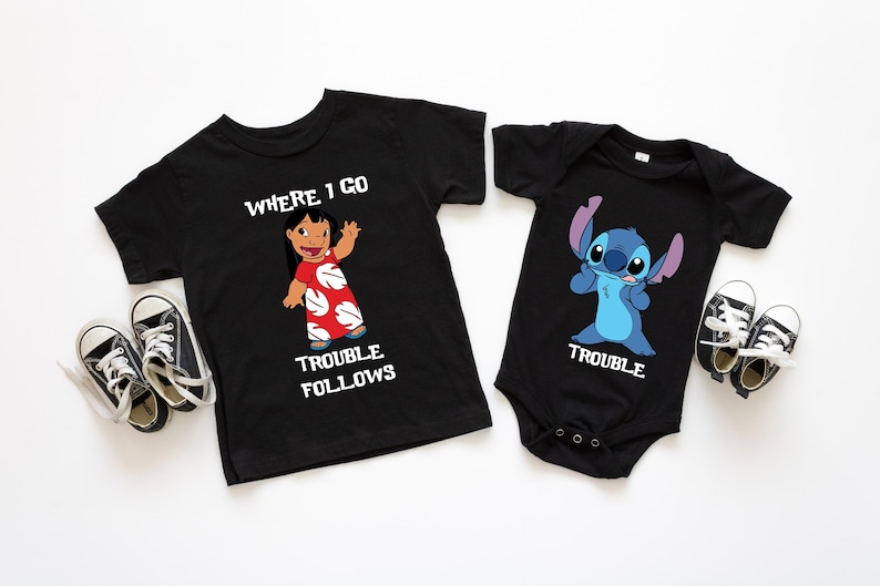 The image displays two black t-shirts with cartoon characters and text printed on them, along with a pair of black and white sneakers.