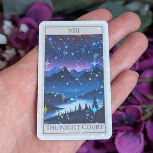 May include: A tarot card with a blue and purple mountain scene under a starry night sky. The card is labeled "VIII THE NIGHT COURT".