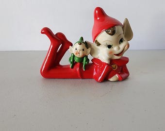 1950s Red Reclining Christmas Elf With Little Green Elf On Back Figurine