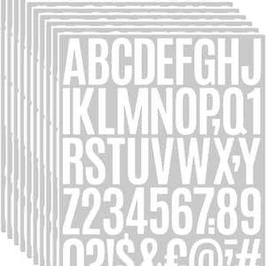 May include: A stack of gray adhesive sheets with white uppercase letters, numbers, and symbols. The letters include the alphabet, numbers 0-9, and punctuation marks. The sheets are arranged in a neat, organized stack.