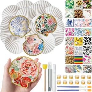 May include: A collection of decorative seashell-shaped items with floral and patterned designs. The image includes craft supplies such as paint, brushes, and applicators. The shells have gold trim and are arranged on a white background.