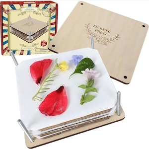 May include: A wooden flower press with a box that reads "Classic Flower Press". The press is open, displaying pressed flowers and petals. The box has red, white, and blue stripes and stars.
