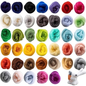 May include: A collection of colorful wool roving in various shades, including blue, green, yellow, and red. The wool is arranged in small, round bundles, perfect for crafting projects. A small, white and orange felted bunny is in the bottom right corner.
