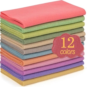 May include: A stack of 12 sheets of felt in various colors, including pink, green, beige, and purple. A red cloud-shaped tag displays the text "12 colors". The felt sheets are neatly stacked, showcasing a range of pastel and vibrant hues.
