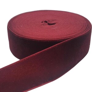 May include: A roll of deep red velvet ribbon. The ribbon is soft and plush, perfect for adding a touch of elegance to any project.
