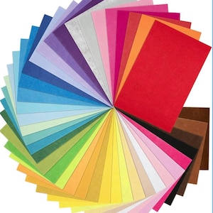 May include: A vibrant assortment of felt sheets in a rainbow of colors, fanned out to display the full spectrum. The sheets range from deep reds and oranges to blues, greens, and yellows, with a few neutral tones. Ideal for crafting and DIY projects.