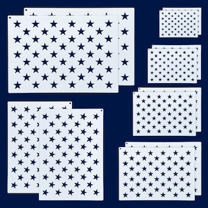 May include: A collection of white stencils featuring a pattern of dark blue stars. The stencils are rectangular and come in various sizes, with small holes at the top for hanging. The background is a solid dark blue.