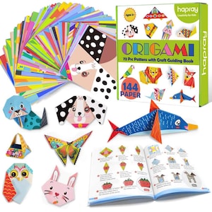 May include: A colorful origami paper set with 144 sheets of paper and a book with 72 origami patterns. The box is green and has the text "hapray Creativity for Kids" on it. The paper is arranged in a fan shape and includes a variety of colors and patterns. The book is open to a page showing instructions for folding a strawberry.