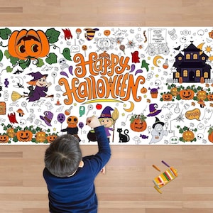 May include: A large white Halloween-themed coloring mat with orange and black illustrations. The mat features pumpkins, witches, ghosts, and the words "Happy Halloween" in orange. A child is coloring the mat with crayons.