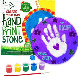 May include: A craft kit for creating handprint stones. The kit includes a stone mold, paint strip, plaster mix, paint brush, and mixing tool. The finished keepsake stone is 7 inches by 7 inches. The image shows a purple handprint stone with the text "To Mom" and "From Sam".