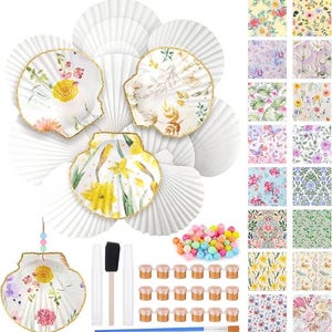 May include: A craft kit featuring multiple white scallop-shaped shells, some with floral and botanical patterns and gold-painted edges. The set includes a collection of colorful beads, a foam brush, two glue pens, a paintbrush, and eighteen small paint pots.
