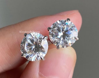 May include: A pair of silver stud earrings with large, clear, round cubic zirconia stones.