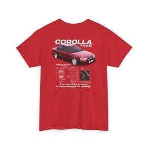 May include: Red t-shirt with a graphic of a red Toyota Corolla. The design includes the word "COROLLA" above the car image, with additional text and diagrams below. The text reads "The car that proves a commitment to quality."