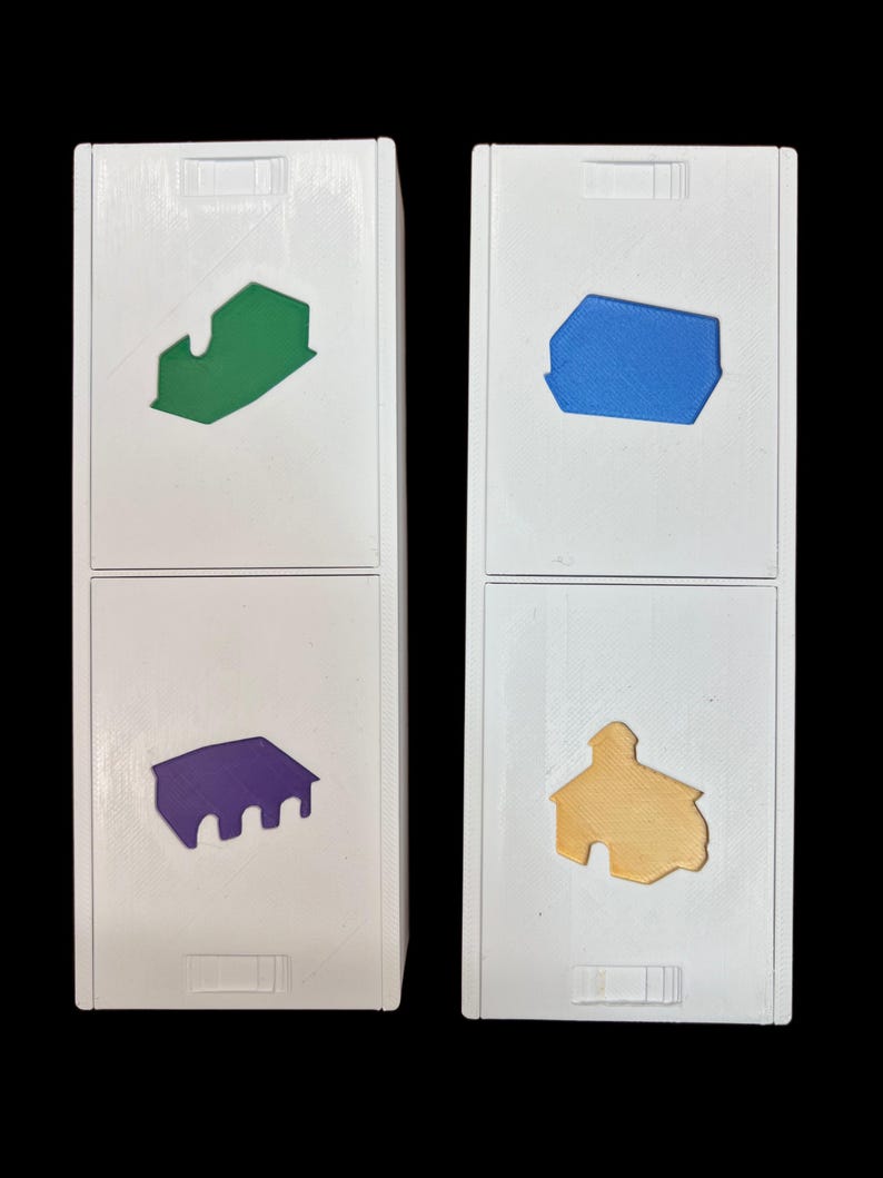 May include: Two white boxes with different colored shapes on each side. The top left box has a green house shape, the top right box has a blue house shape, the bottom left box has a purple house shape, and the bottom right box has a yellow house shape.