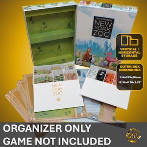 May include: A green and white organizer box for the board game "New York Zoo". The box has compartments for storing game pieces and cards. The box is labeled "New York Zoo" and has a label that says "Vertical/Horizontal Storage". The box is 12.36 inches by 8.78 inches by 2.28 inches.