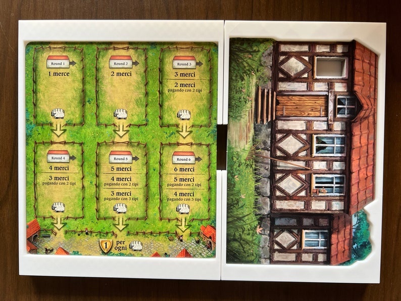 May include: A game board with six rounds of play, each with a different number of sheep and a corresponding number of "merci" points. The board is made of cardboard and has a green background with brown fences. The board is divided into six sections, each with a different number of sheep. The board also has a small house on the right side.