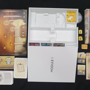 May include: A board game set with various components, including a game board, cards, and tokens. The game box is white with the text "MODULE I". The game board features a detailed illustration with warm colors.