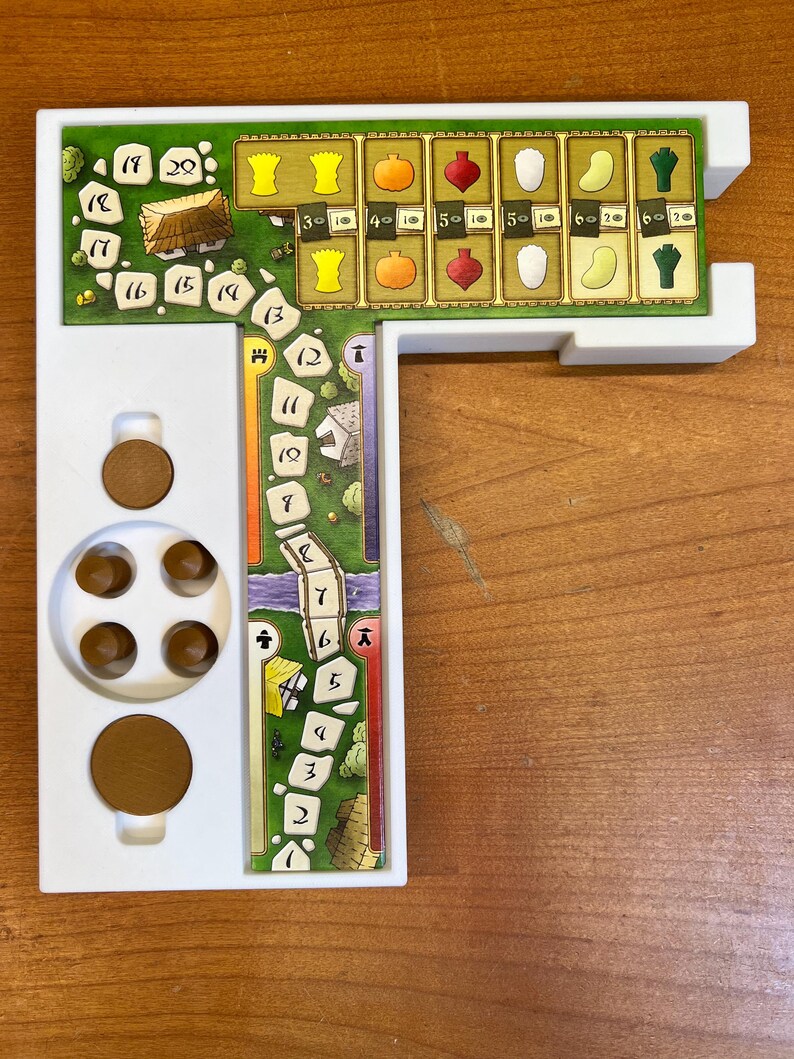 May include: A white plastic game board with a green and brown game track, a white plastic scoring area with numbers 1-20, and a white plastic scoring area with numbers 30-60. The game board is designed for a board game.