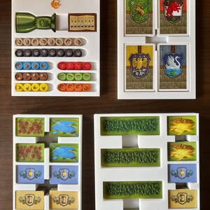 May include: White plastic organizer with compartments for storing game pieces and cards. The organizer has the words "Glass Road" printed on the top. The organizer has compartments for storing different colored tokens, dice, and cards.
