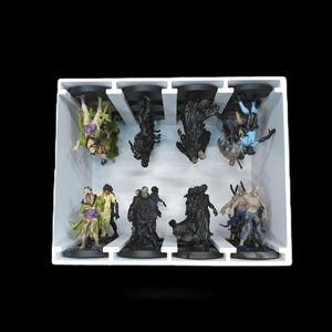 May include: A white tray holds eight miniature figurines. The figurines are of various characters, some in green, purple, and blue, others in black. The figures are on black bases.