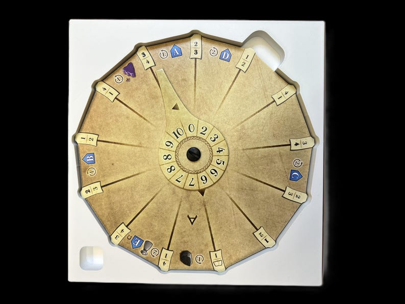 May include: A circular game board with a rotating dial in the center. The dial has numbers 0 through 9. The board has 12 sections with numbers 1 through 3 and symbols. The board is beige with brown accents.