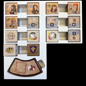 May include: A white game board with various game pieces, including cards, dice, and tokens. The board has a white background with black lines and a brown wooden frame. The game pieces are arranged in a grid pattern on the board. The cards are all different colors and have different images on them. The dice are all white and have black dots on them. The tokens are all different shapes and sizes and have different colors on them.