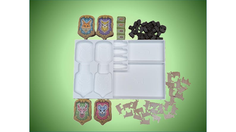 May include: A white plastic storage tray with compartments for game pieces. The tray contains four colorful shields with animal illustrations, a set of wooden cubes, and a collection of brown wooden pieces.
