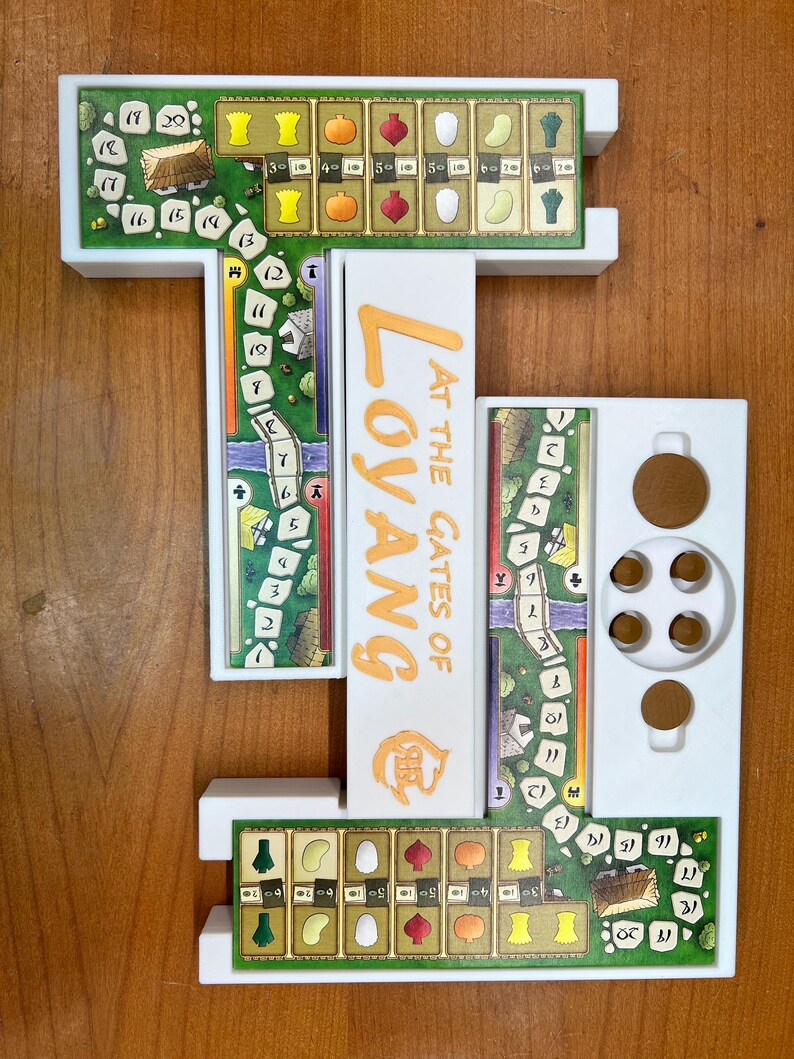 May include: A white plastic game board organizer for the board game "At the Gates of Loyang". The organizer has three sections, one for the game board, one for the player boards, and one for the game components. The organizer is designed to keep the game organized and easy to set up.