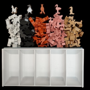 May include: A white wooden storage box with five compartments for organizing small items. The box is filled with colorful wooden animal figurines, including penguins, kangaroos, flamingos, and deer.