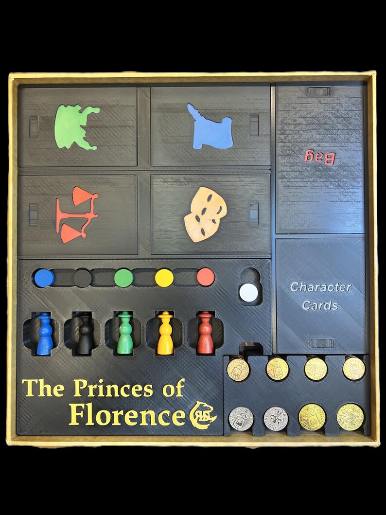 May include: The Princes of Florence board game insert with compartments for game pieces, character cards, and coins. The insert is black with gold lettering and includes a bag for storing game pieces.