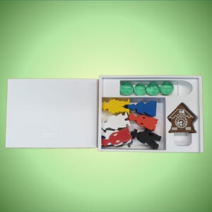 May include: A white box with a cuckoo clock, five wooden figures, and five green chips inside. The figures are red, yellow, blue, white, and black.