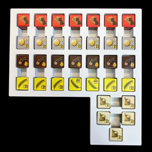 May include: A white tray with compartments containing various game pieces. The pieces are small, square, and feature different colors and images, including red bricks, gold coins, brown logs, yellow wheat, and white flour sacks.