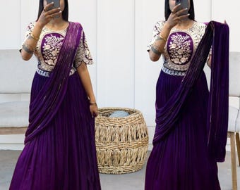 Puede incluir: Un vestido morado con un diseño de bordado floral plateado y blanco. El vestido tiene una falda drapeada y un corpiño ajustado. El vestido lo lleva una persona con el pelo oscuro y una diadema.