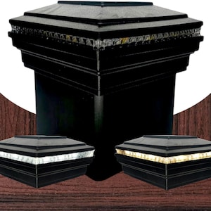 May include: Black post cap with a tiered design and a row of clear, decorative lights. Two smaller versions of the post cap are displayed in the foreground. The caps are square and have a modern aesthetic.