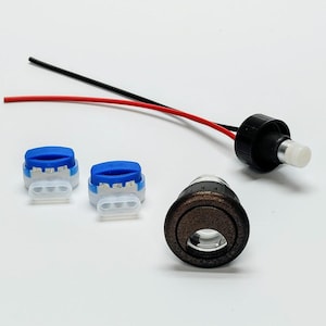 May include: A set of electrical components including a black and white wire, two blue and white wire connectors, a black and white electrical connector, and a round, bronze-colored electrical component.