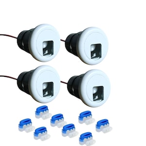May include: Set of four white round LED lights with black bases and blue wire connectors. The lights have a square opening in the front.