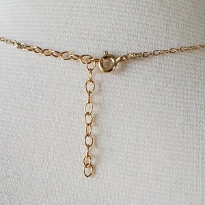 May include: A gold chain necklace with a lobster clasp closure.