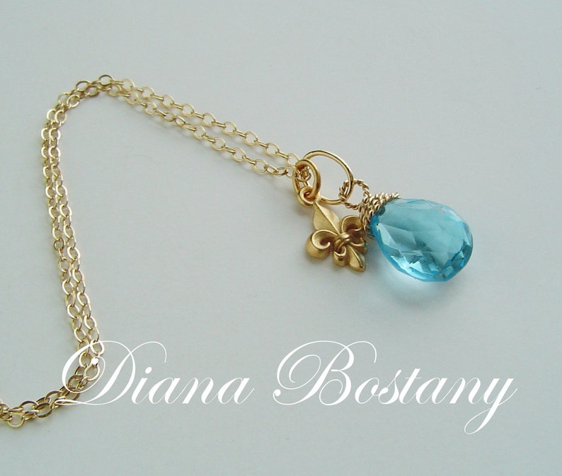 Tiny Fleur de lys Pendant in 24K Gold over Sterling on 14K Gold filled Chain Necklace, Custom lengths available. Shown with Blue Topaz hand wrapped briolette, available separately.
