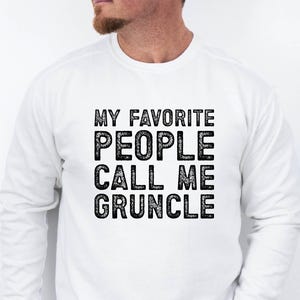 May include: White long-sleeve sweatshirt with black text that reads "My favorite people call me Gruncle".