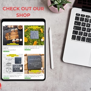 May include: A tablet displays Etsy listings for engraved slate coasters, cheese boards, and trays. A laptop, a white stylus, and a small potted plant are also visible. The text "CHECK OUT OUR SHOP" is at the top, and the shop's logo is at the bottom.