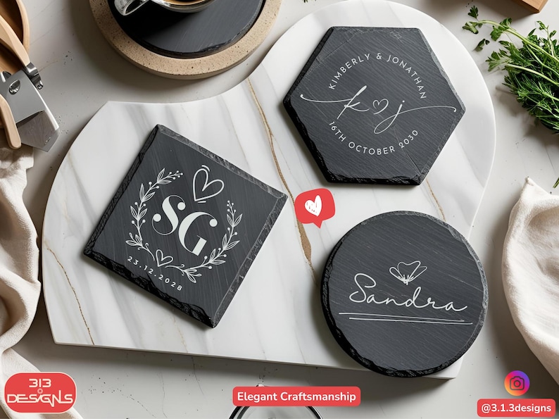 May include: Slate coasters with personalized designs. One square coaster features the initials "SG" with a heart and floral wreath, dated 23.12.2028. A hexagonal coaster displays "Kimberly & Jonathan" and the date 16th October 2030. A round coaster has the name "Sandra".