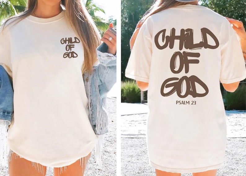 A woman wearing a white t-shirt with the text "CHILD OF GOD" printed on it, standing in a natural outdoor setting.