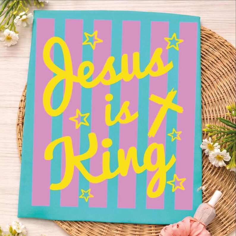 A colorful poster with the text "Jesus is King" in yellow and pink letters, surrounded by pink and purple stripes and stars.