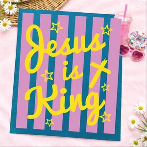 A colorful sign with the text "Jesus is King" in yellow and pink letters, surrounded by stars and flowers.
