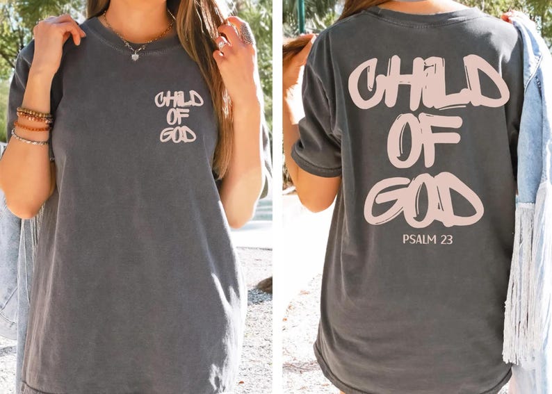 a woman wearing a gray t-shirt with the text "CHILD OF GOD" printed on it. The back of the t-shirt also displays the text "PSALM 23" along with a graphic of a Bible verse.
