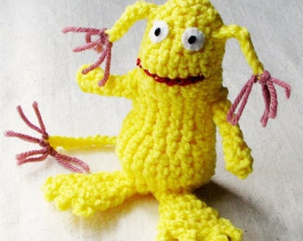 Whimsical monster, crocheted in bright lemon yellow with dusty rose tassels on ears and tail, 5 inches tall