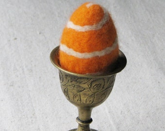Easter egg, needle felted from wool in bright carrot orange with a cream spiral stripe design